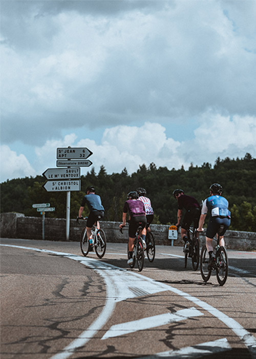 Cyclists on road bikes ride back to Sault after Mont Ventoux climb via Bédoin